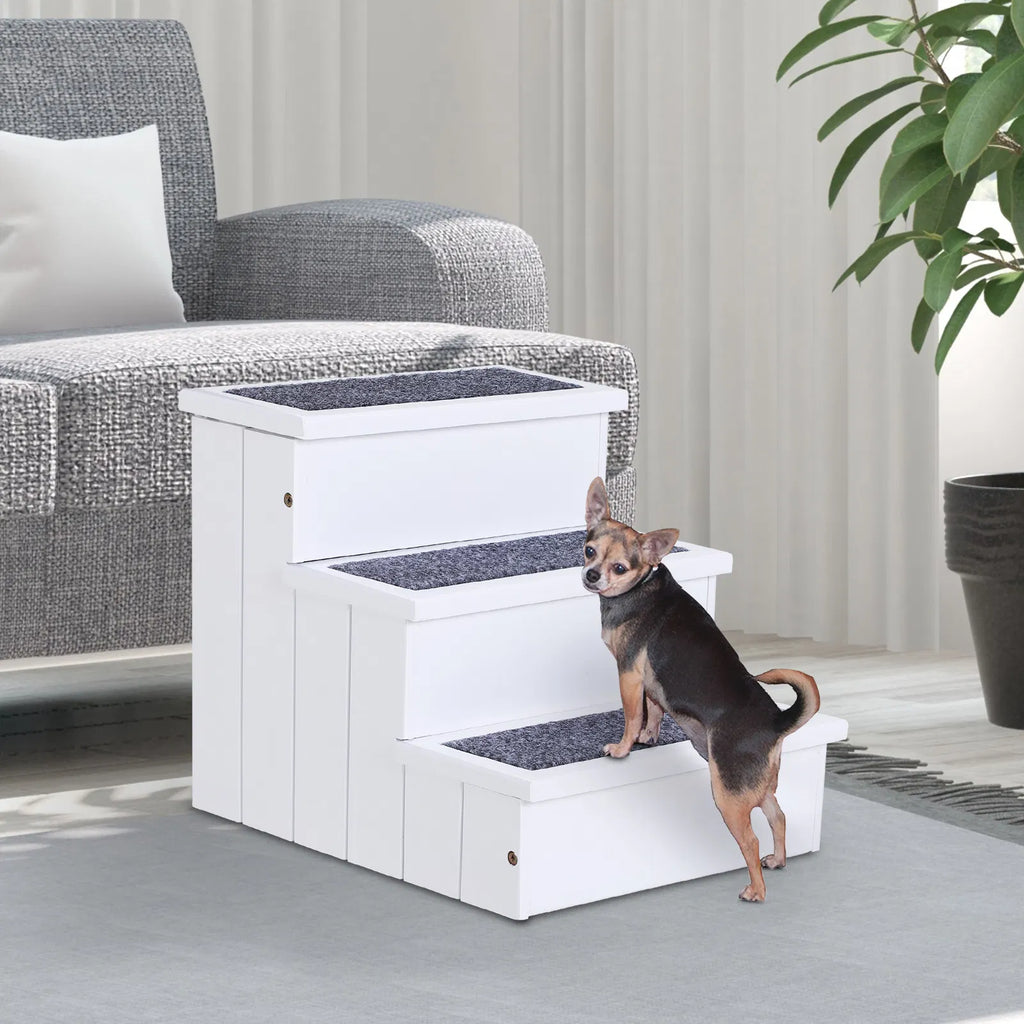 Small dog climbing the white Cloud Steps carpeted pet stairs next to a gray sofa