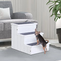Small dog climbing the white Cloud Steps carpeted pet stairs next to a gray sofa
